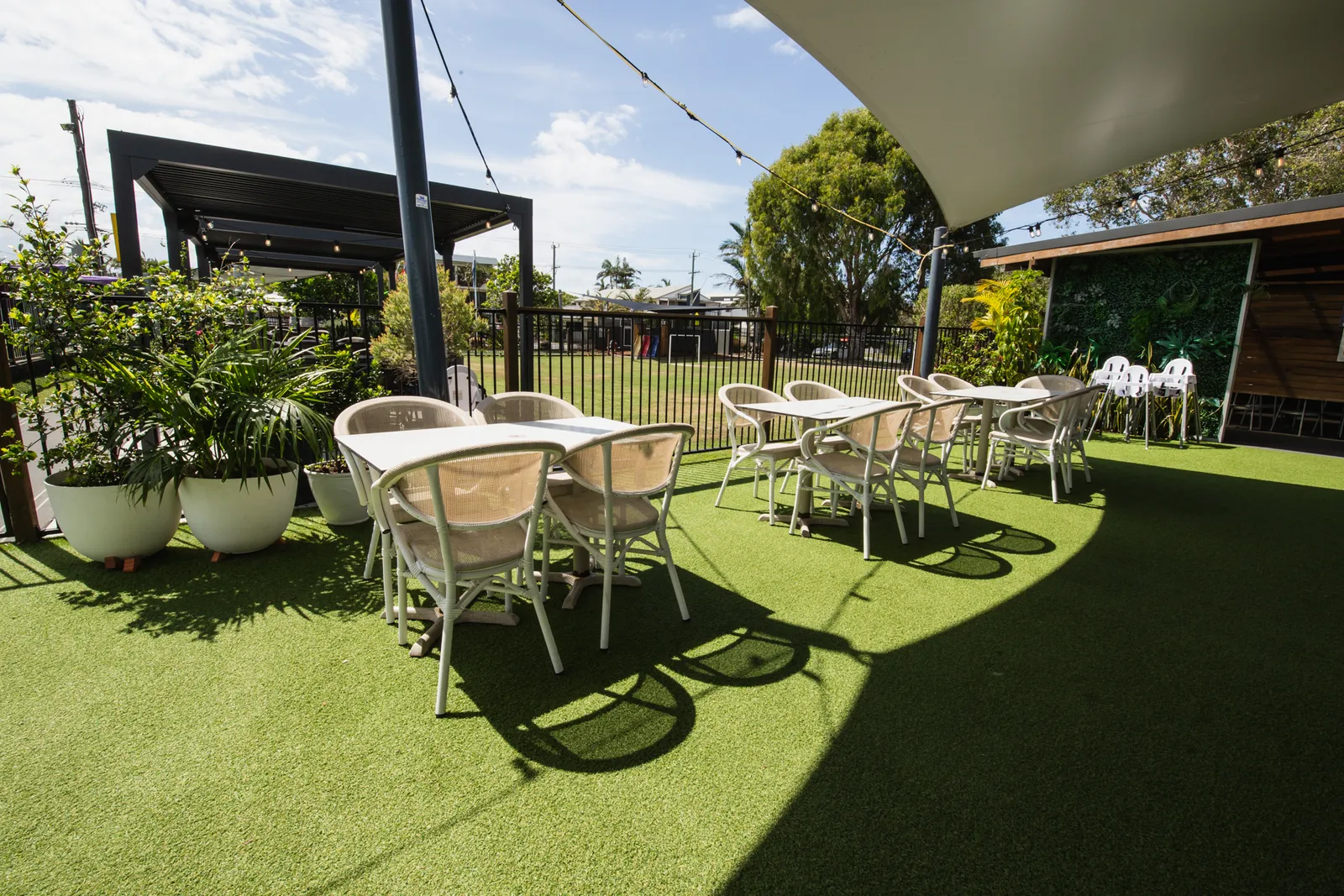 The shaded beer garden set with tables and string lights